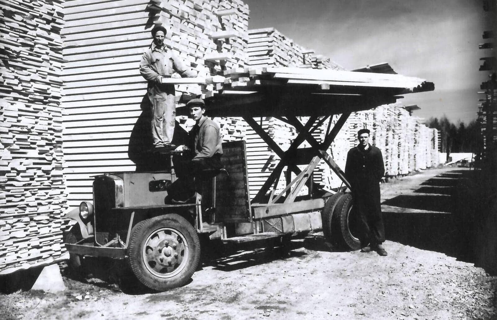 Sawmill workers prepare lumber for drying